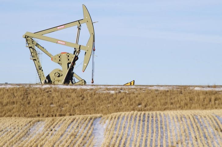 Oil prices settle lower, but notch second-monthly gain on tighter supply hopes
