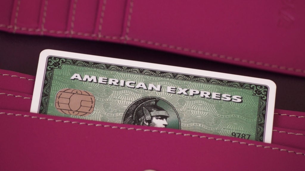 an American Express (AXP) credit card sticking out of someone